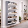 Wall-mounted 4-door grey metal shoe rack with white frame installed near wooden entrance door – space-saving premium Jootarack shoe storage cabinet