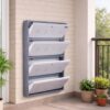 Wall-mounted 4-door grey metal shoe rack with white frame installed near wooden entrance door – space-saving premium Jootarack shoe storage cabinet