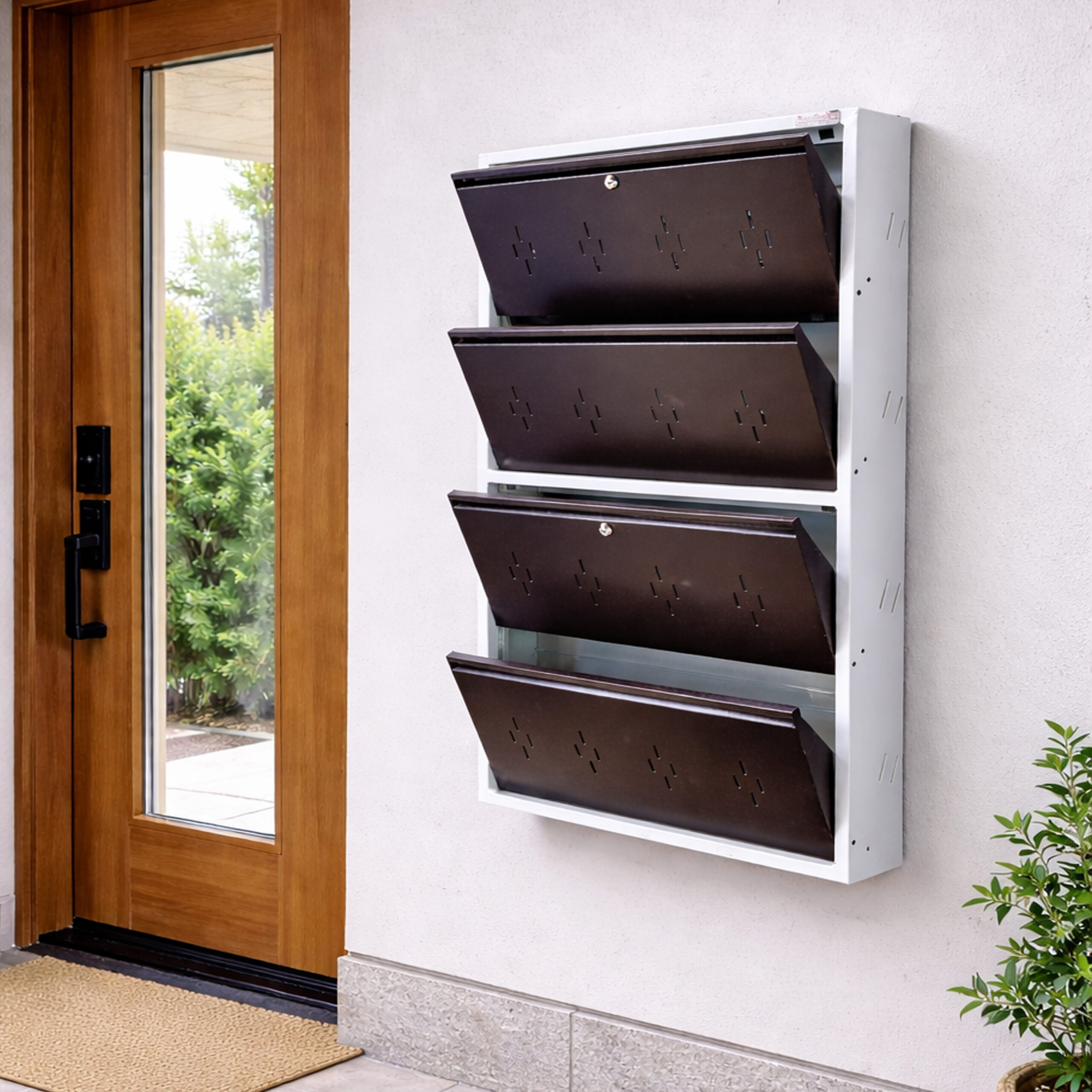 Wall-mounted 4-door grey metal shoe rack with white frame installed near wooden entrance door – space-saving premium Jootarack shoe storage cabinet