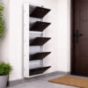 Wall-mounted 4-door grey metal shoe rack with white frame installed near wooden entrance door – space-saving premium Jootarack shoe storage cabinet